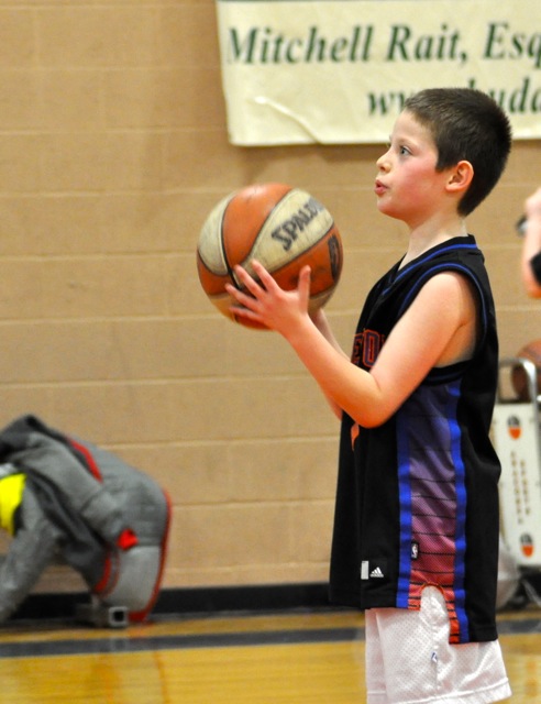 Young Jesse holding a basketball