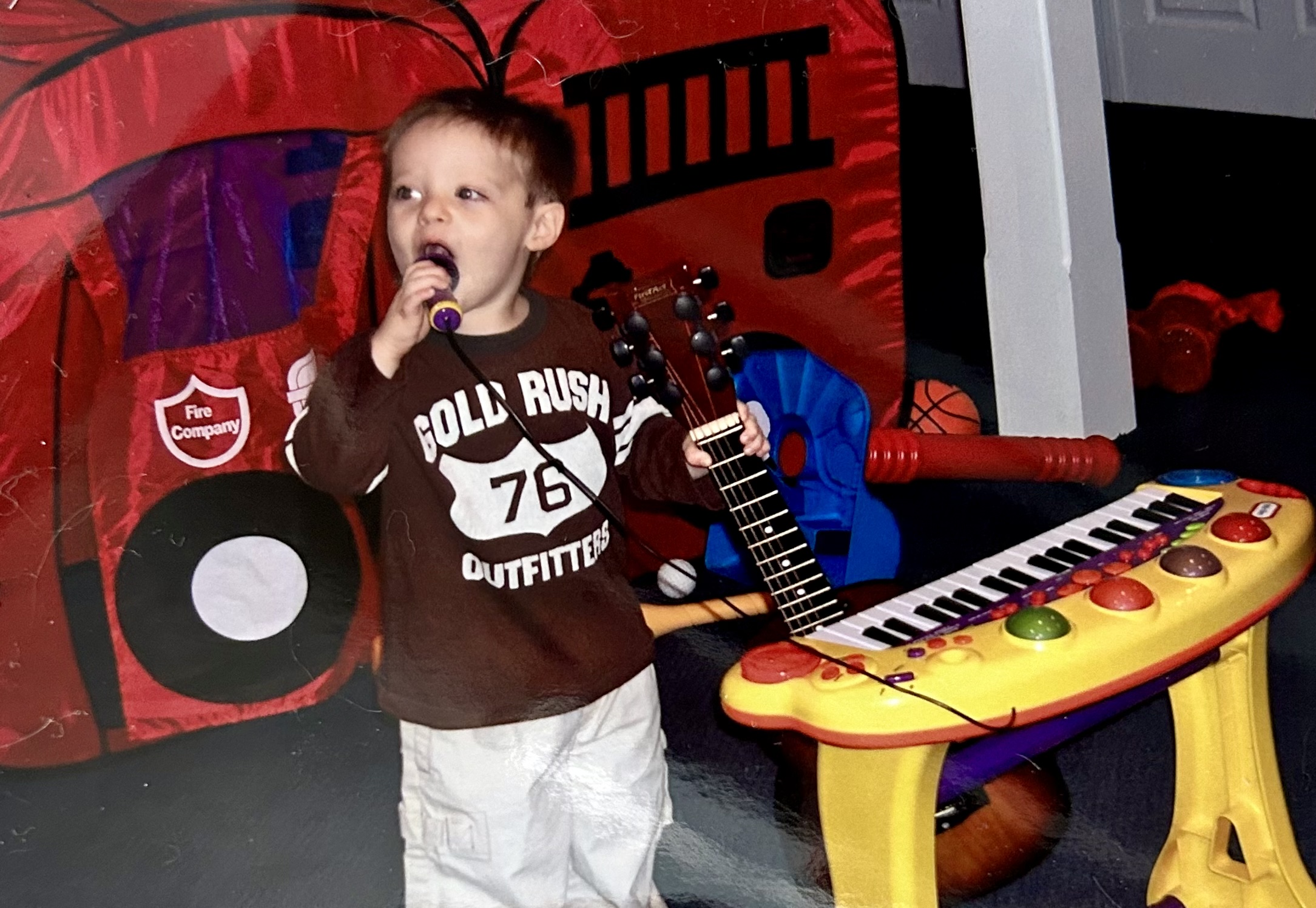 Young Jesse holding a microphone and guitar